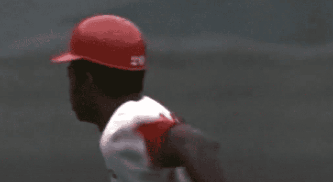 Lou Brock stealing a base, showcasing speed and strategy in baseball.